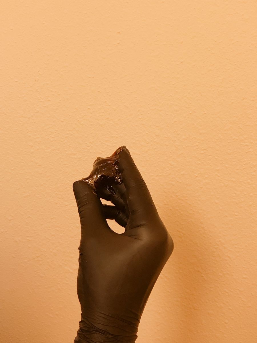 Sugarist holding a sugaring ball for hair removal